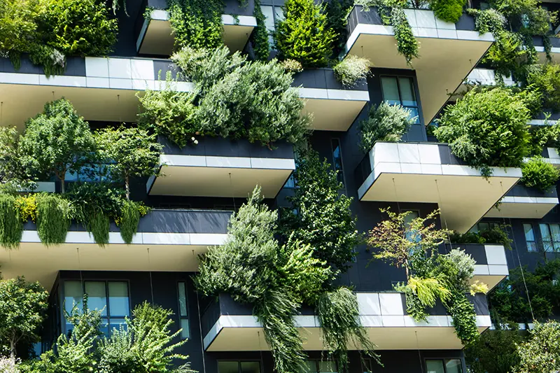 Fassade eines Gebäudes mit dicht begrünten Balkonen